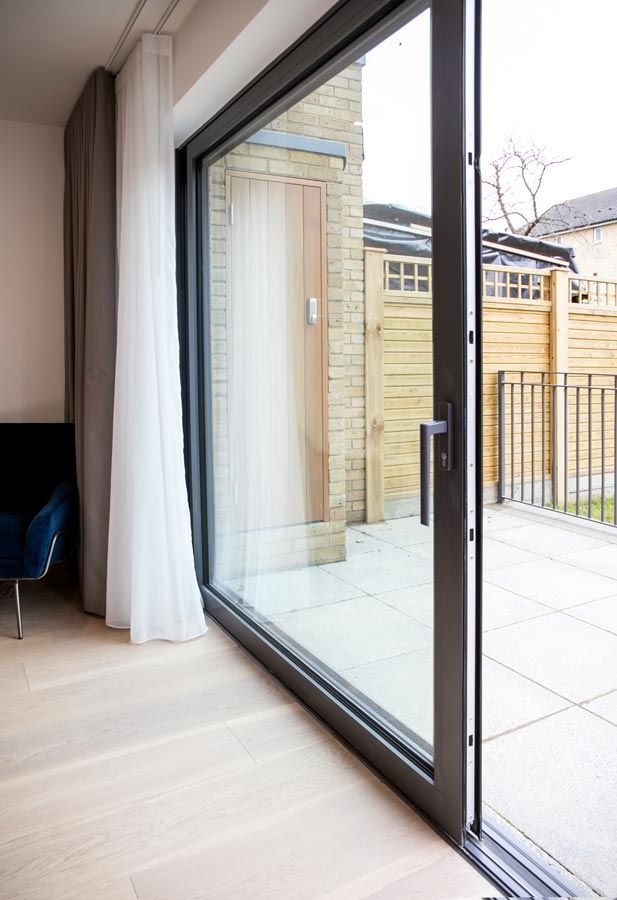 Modern sliding glass patio door opening to outdoor terrace