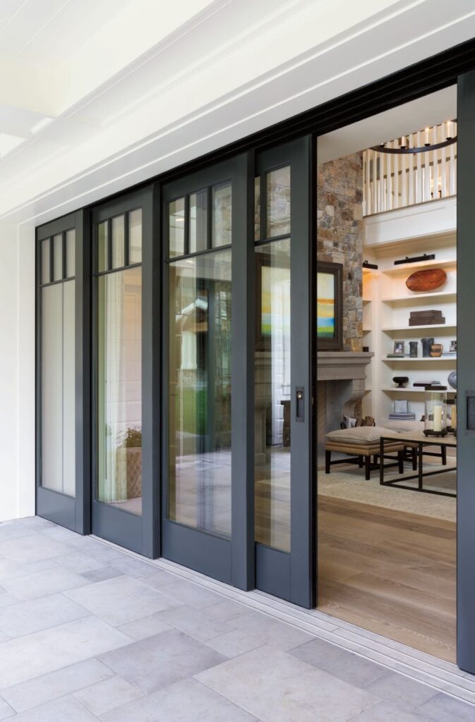 Modern black sliding glass patio doors opening to bright interior