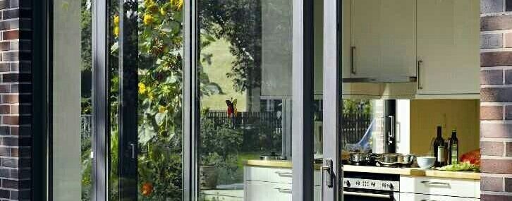 Modern aluminum sliding patio door opening to exterior deck