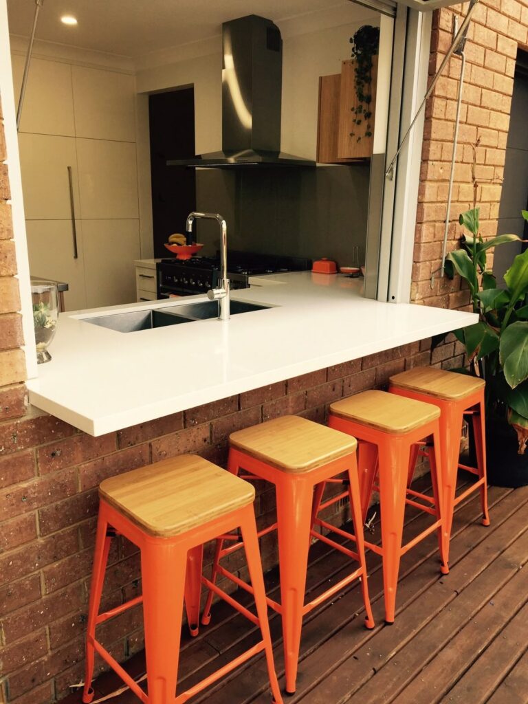 Passthrough kitchen window with outdoor bar counter and stools