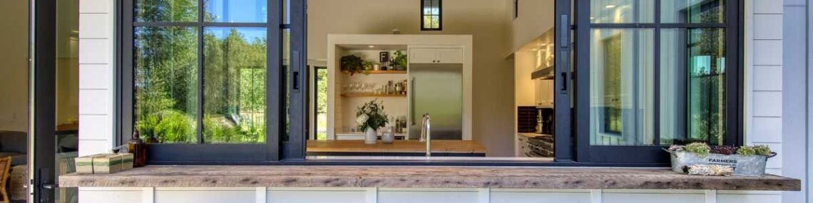 Outdoor passthrough kitchen window with bar seating and stools