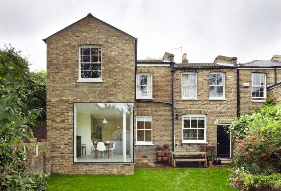 Brick house extension featuring large modern picture window design
